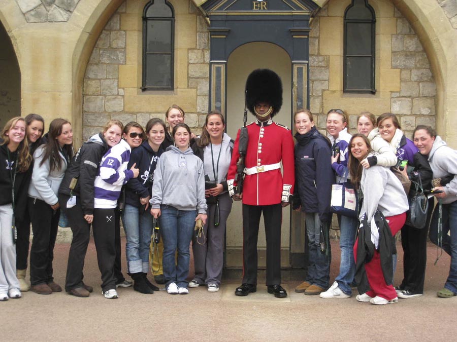 girls lacross team with british guard