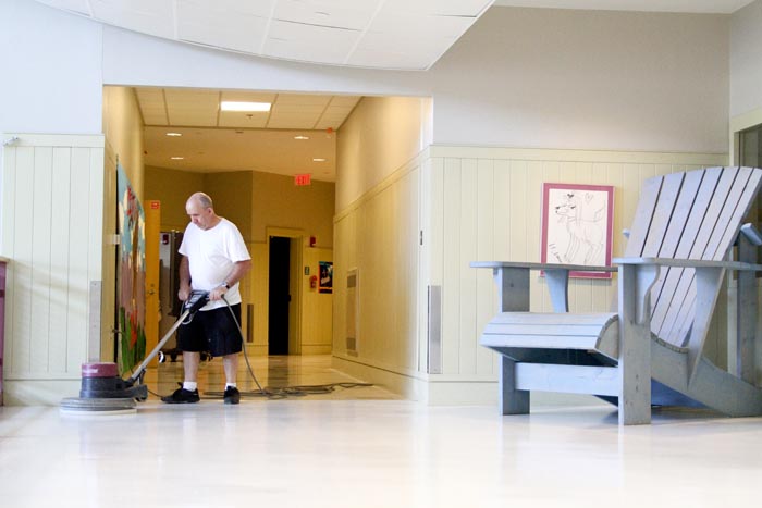 Malcolm Broadbent school hallway custodian