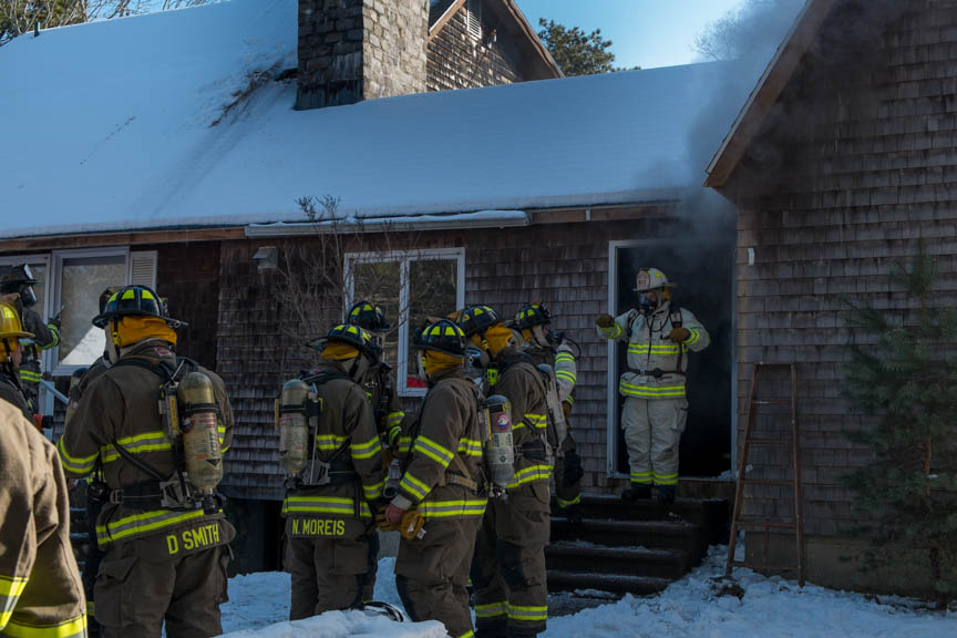 Firemen go inside to put the fire out.