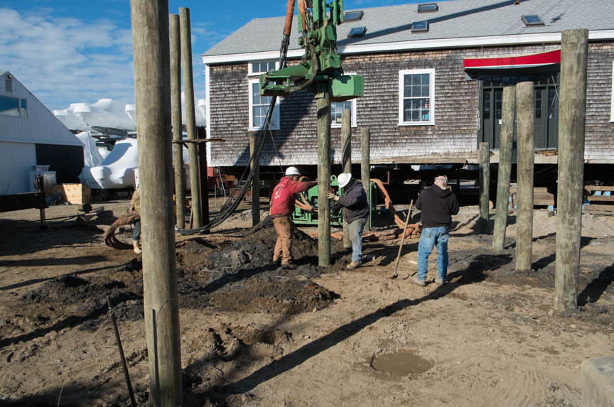 New spiles are driven into the ground at the old site.