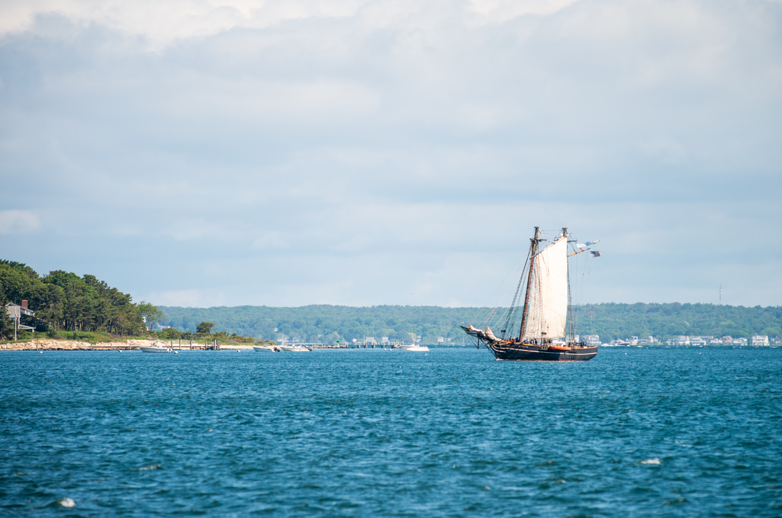 The sails are slowly brought in as the harbor looms closer.