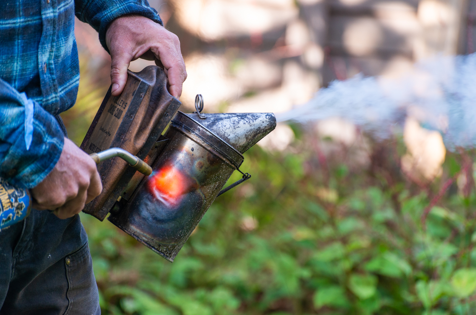 Tim Colon (of Island Bee Company) heating up his smoker.