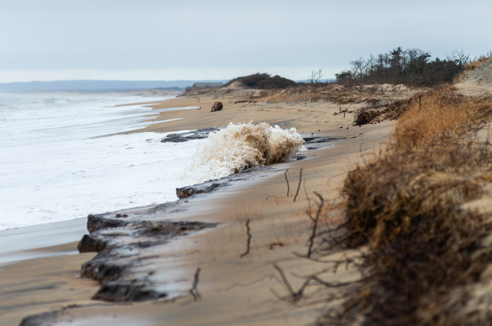 Waves break over fresh erosion signs on South Beach.