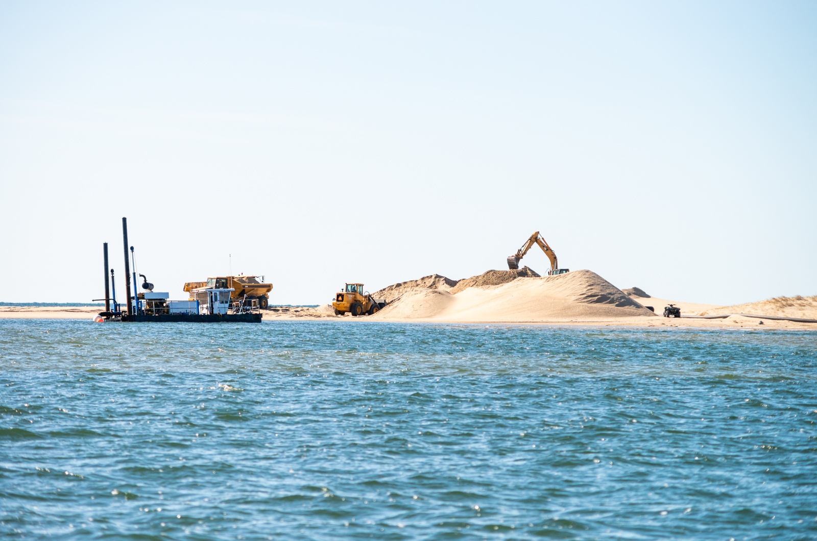 Dredge and excavation equipment seen from the pond.