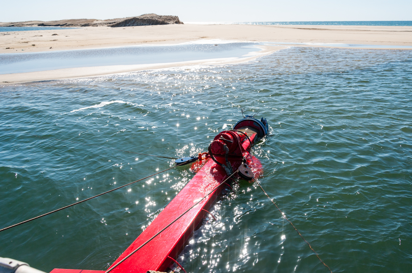 Dredge snout extending into the water.