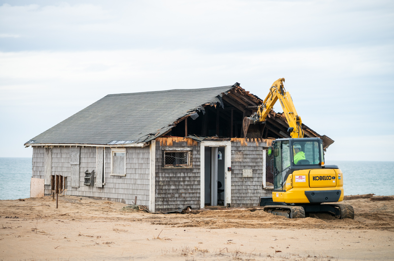 The street-facing wall begins to come down.