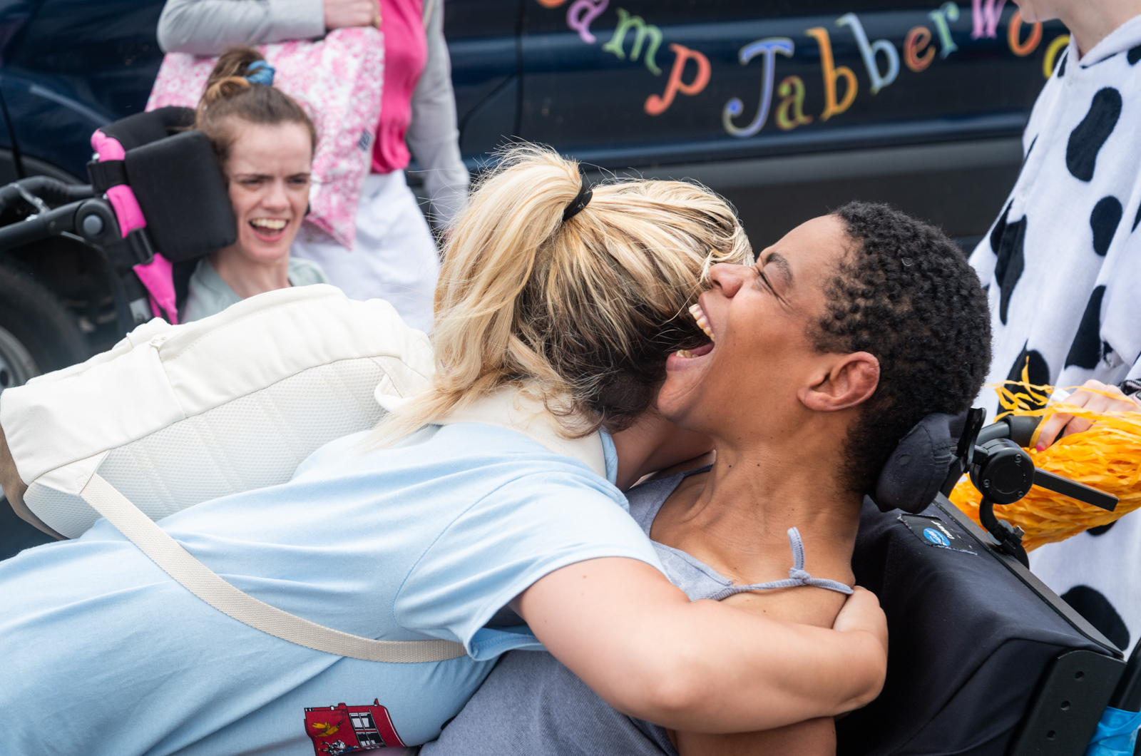 Camp counselor hugs Shirley Reppert (right)