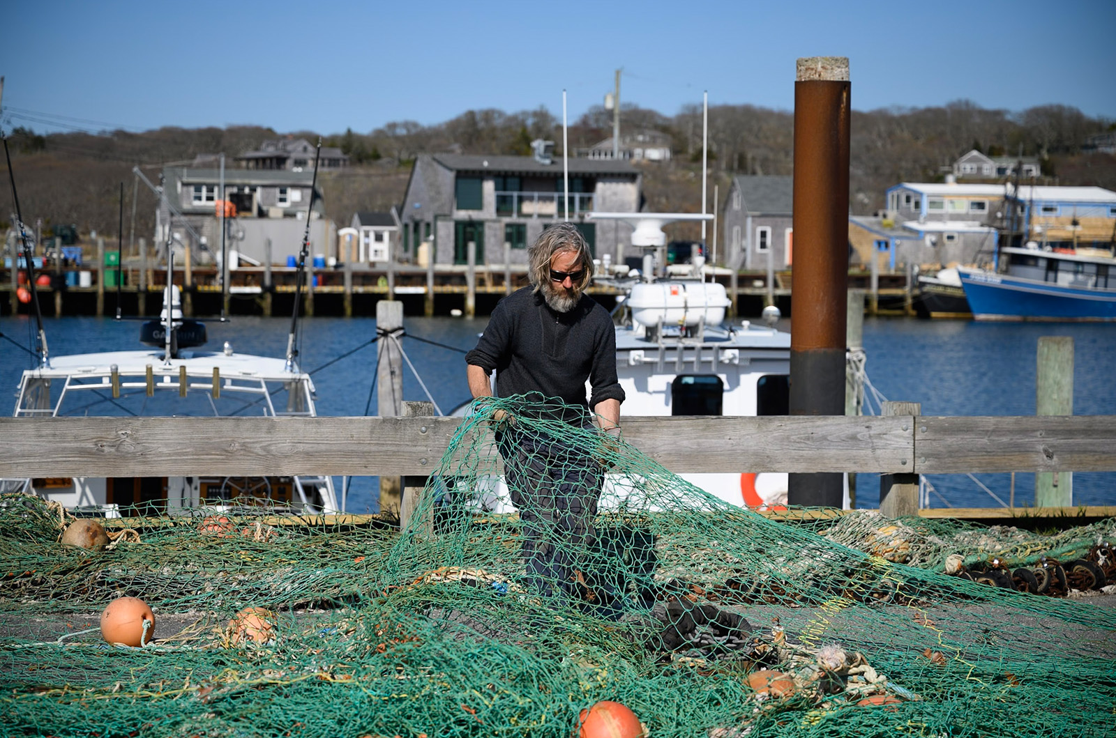 Todd Mayhew with Menemsha harbor behind him.