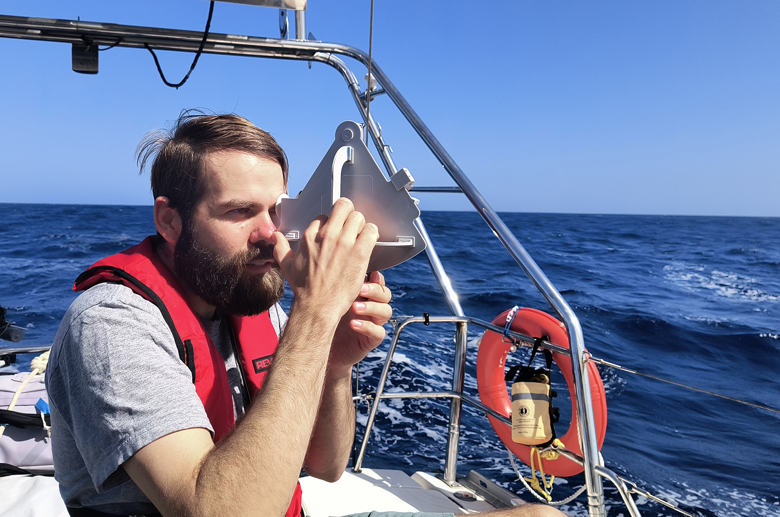 Josh Kegan navigating with a sextant.