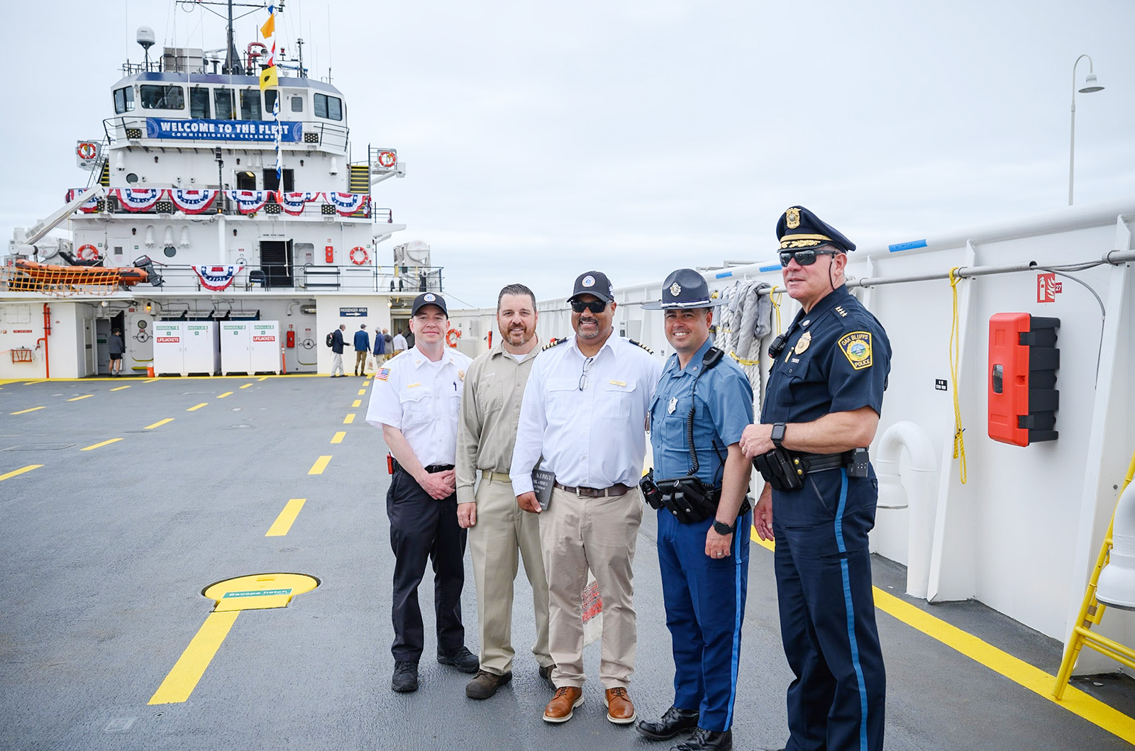 Island law enforcement officials pose with Justin Bond and Captain Norman DeBarros.
