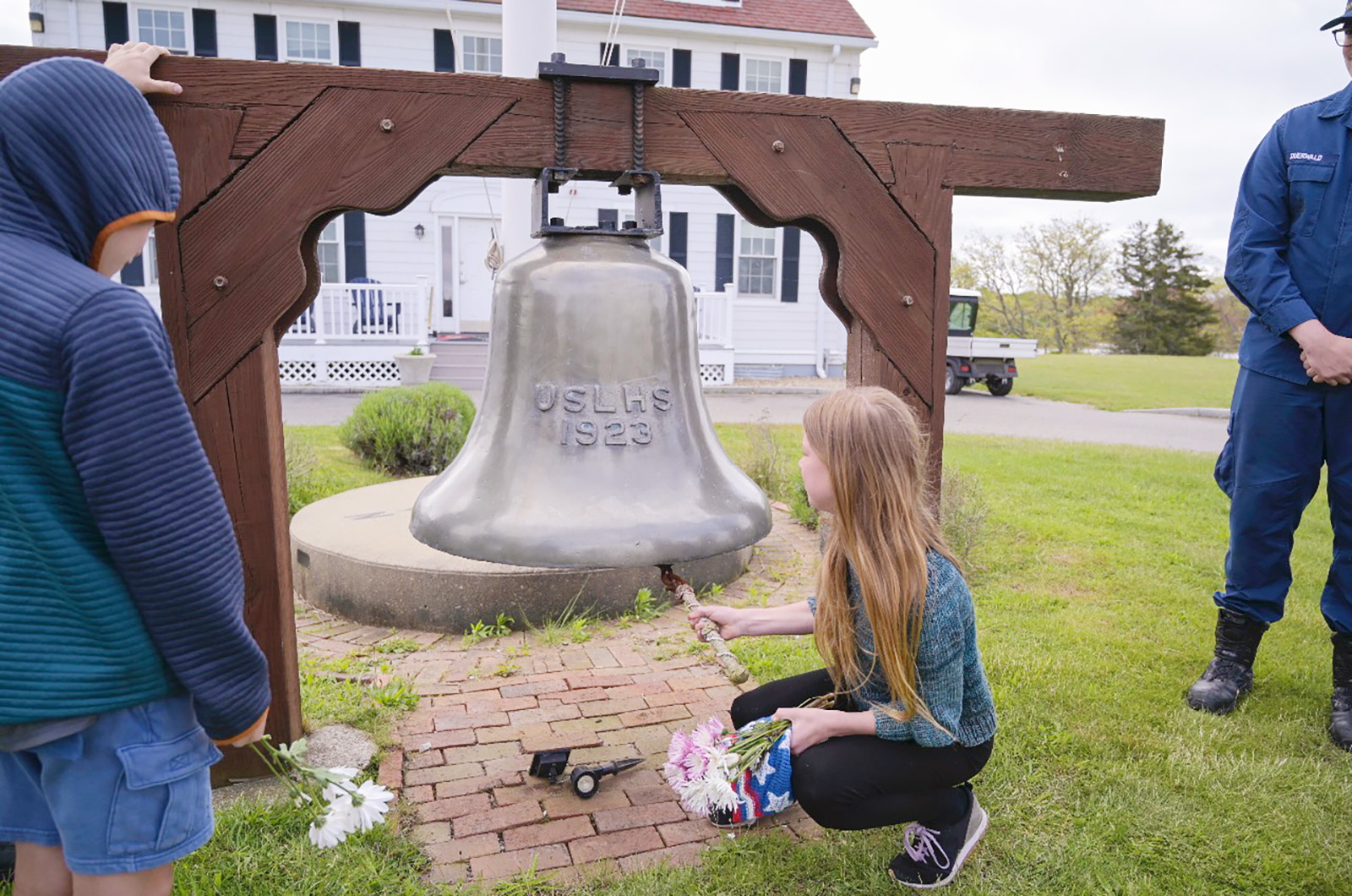 Student rings the bell at the Coast Guard station.