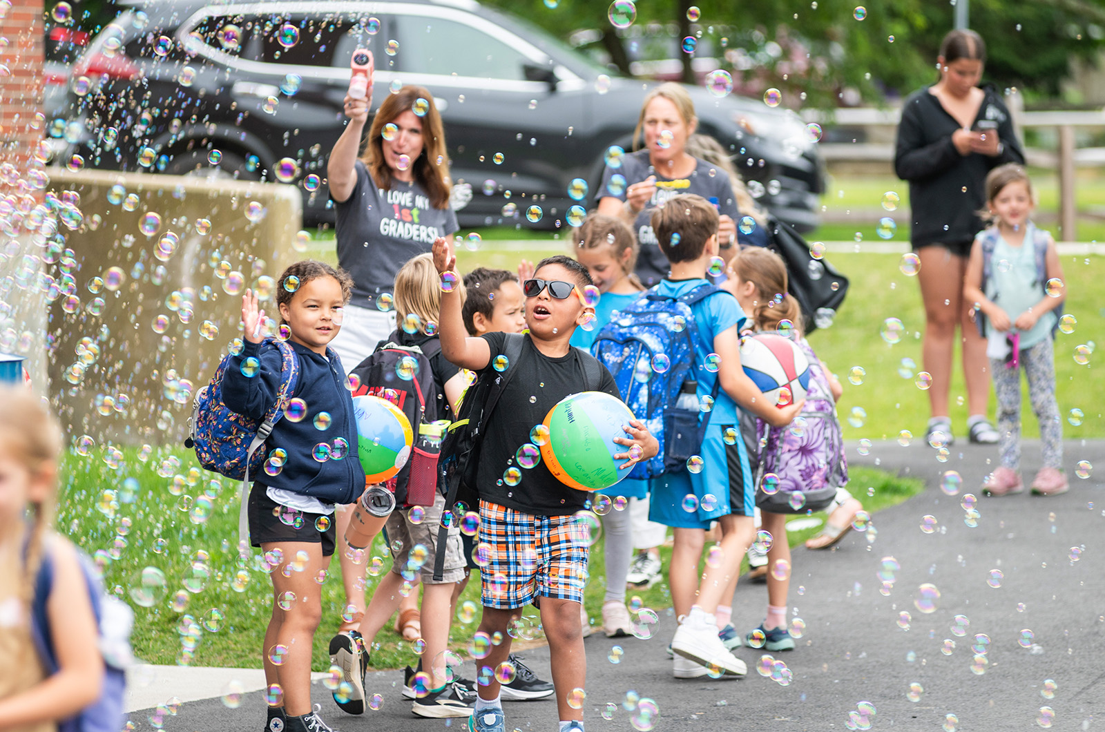 Tisbury school students play with bubbles blown teachers and staff.