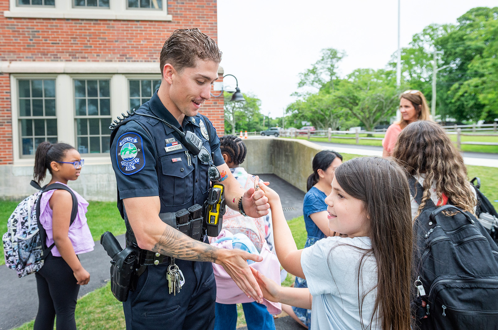 Resource Officer Cory Medeiros plays patty-cake with Scarlett Garcia.