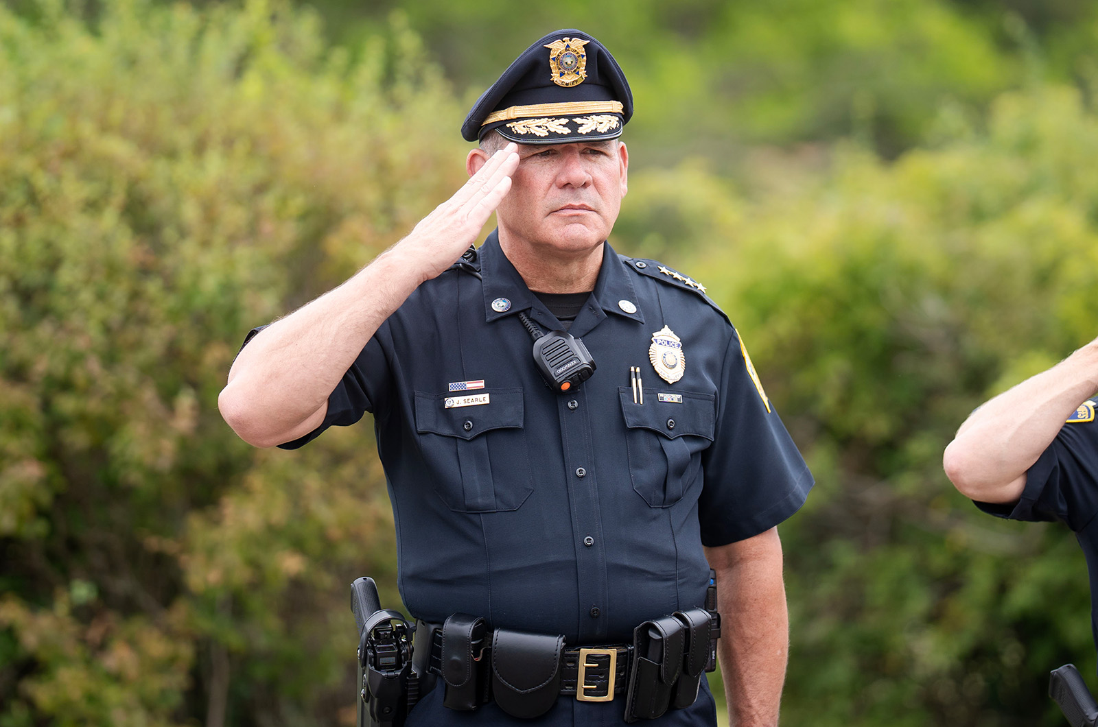Oak Bluffs Chief of Police Jonathan Searle salutes the parade as it passes.