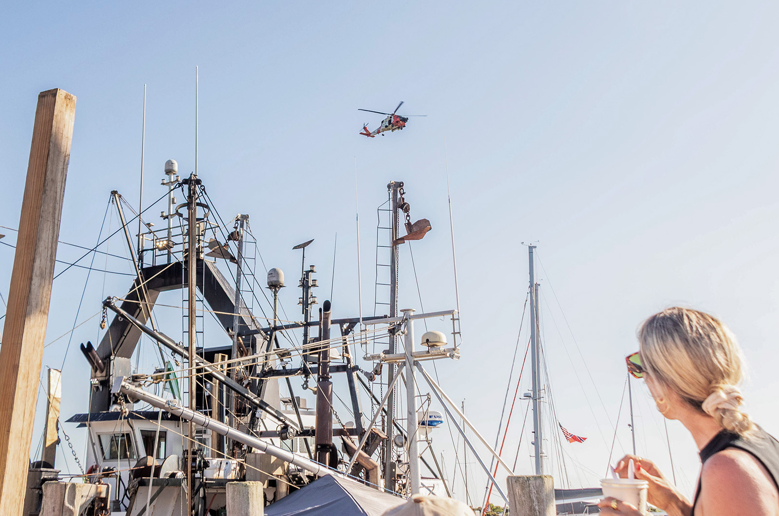A Coast Guard flies over the harbor for a demonstration.