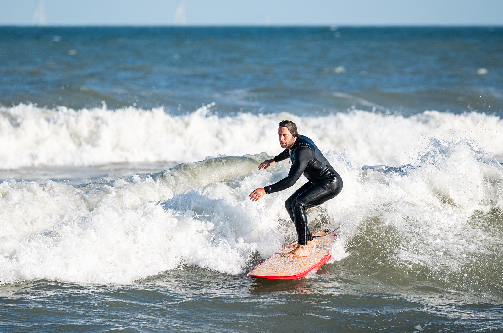 Island surfers make good use of the remnants of the storm after it had passed.