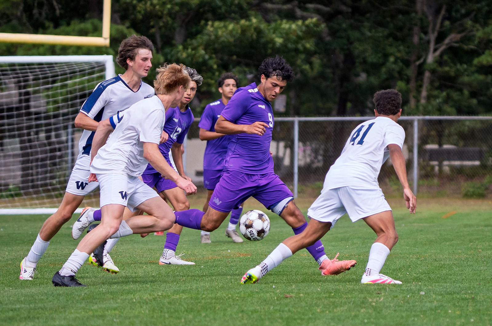 Mateus Lacerda races by Nantucket players.