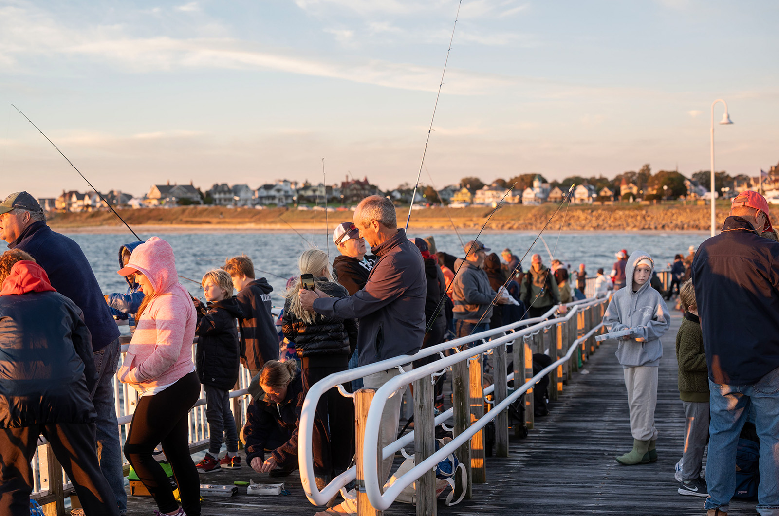 Families line the docks as the sun rises over Oak Bluffs.