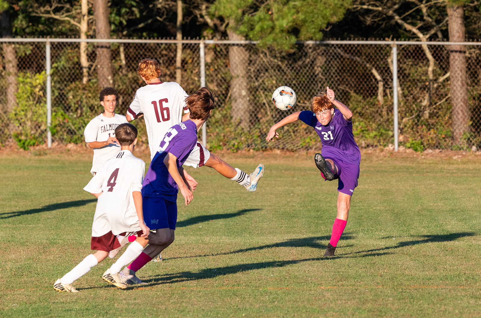 A defender on the JV team clears the ball.