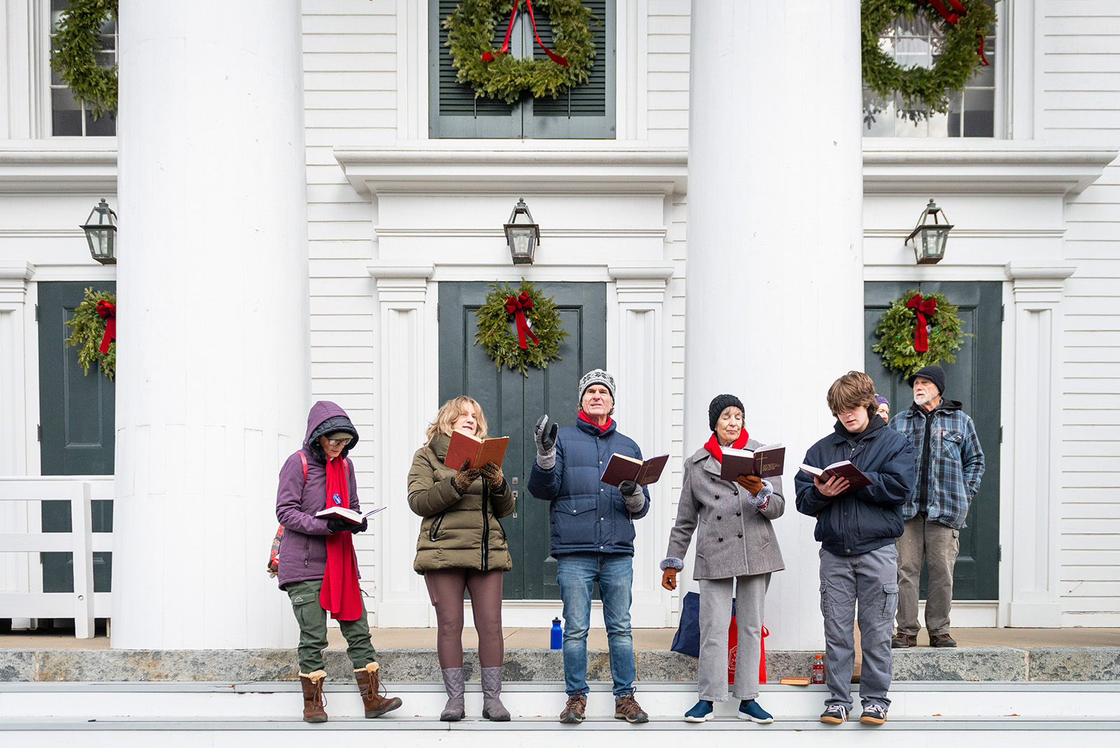 Carolers grace the steps of The Old Whaling Church.