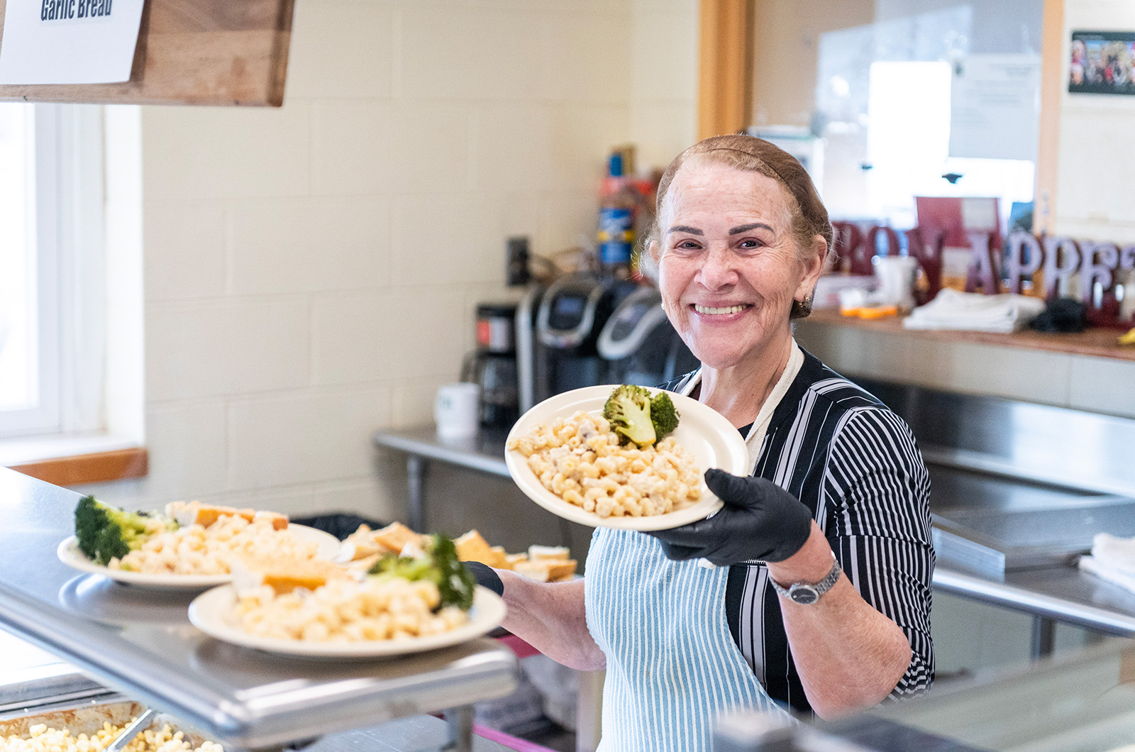 Marlucia Boulet plating food ahead of lunch time.