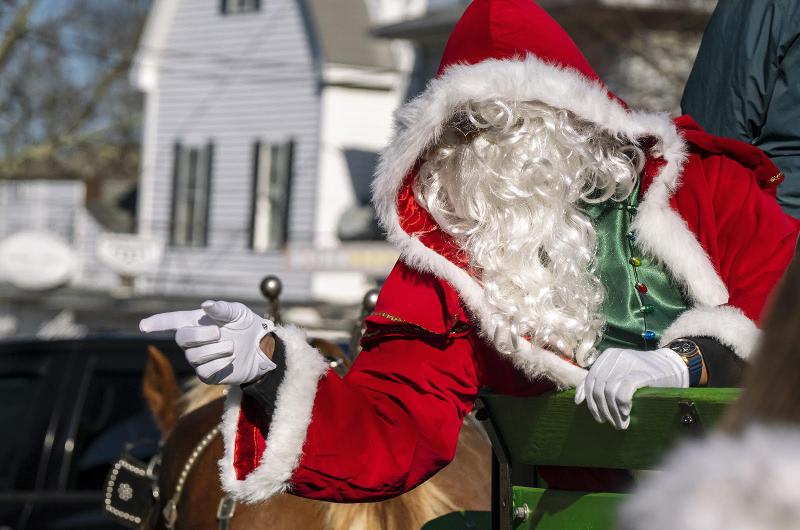 St. Nick is never too busy to great his adoring public.