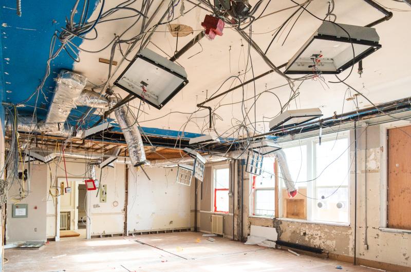 Recessed lighting fixtures remain after drop-ceiling is removed.