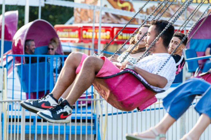 Friends enjoy rides in the carnival.