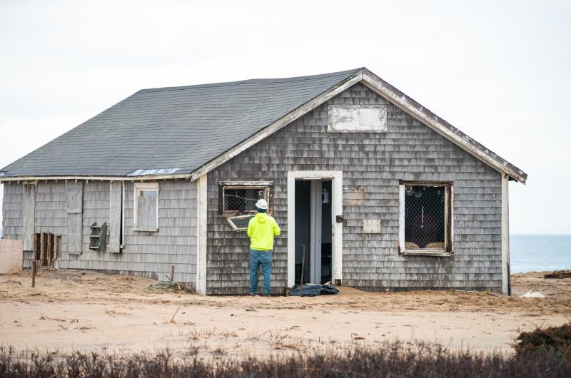 Removing windows before demolition begins.