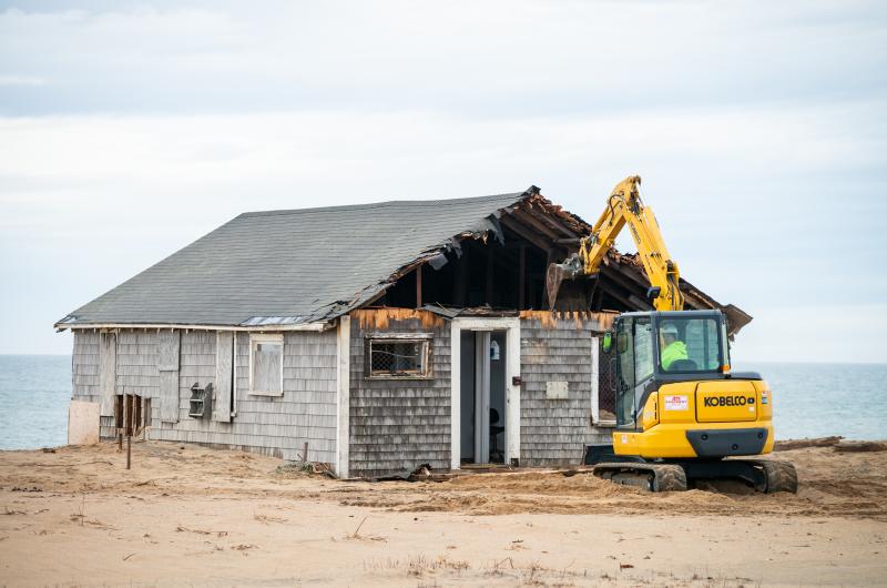 The street-facing wall begins to come down.