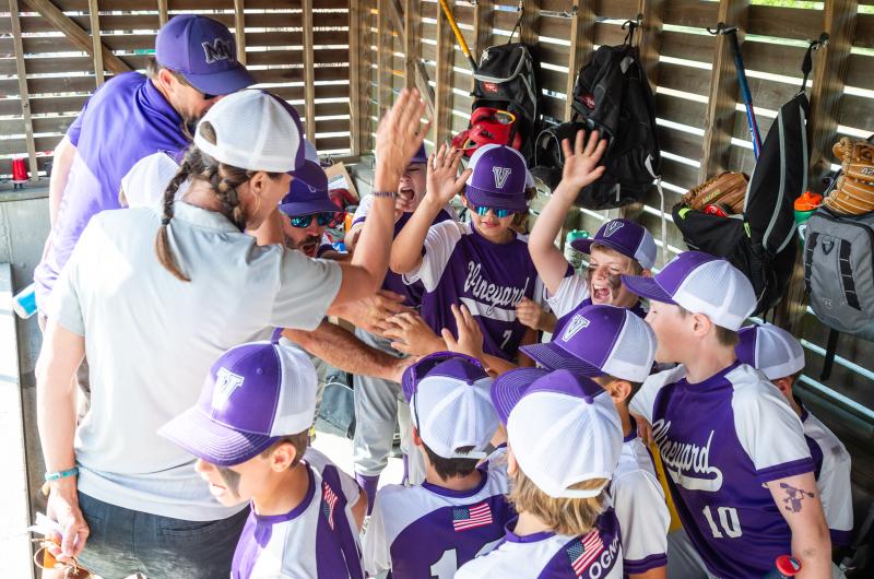 Coaches talk with players before the game.