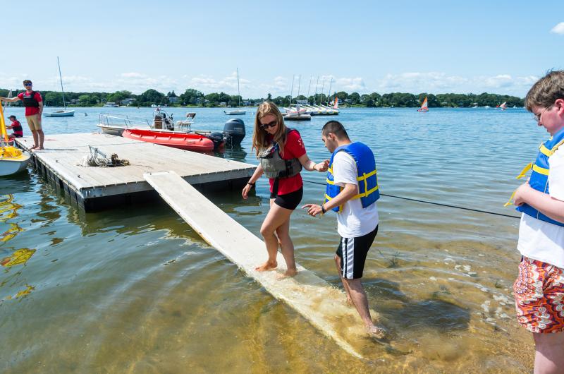 Edie Thorp helping Andres Sanchez Roa up the ramp.