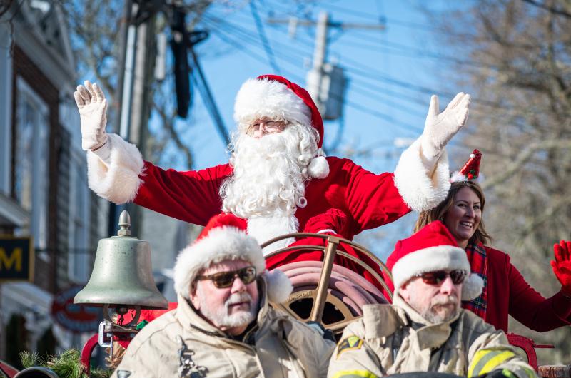 Peter Shemeth and Scott Ellis escort Santa down Main Street.