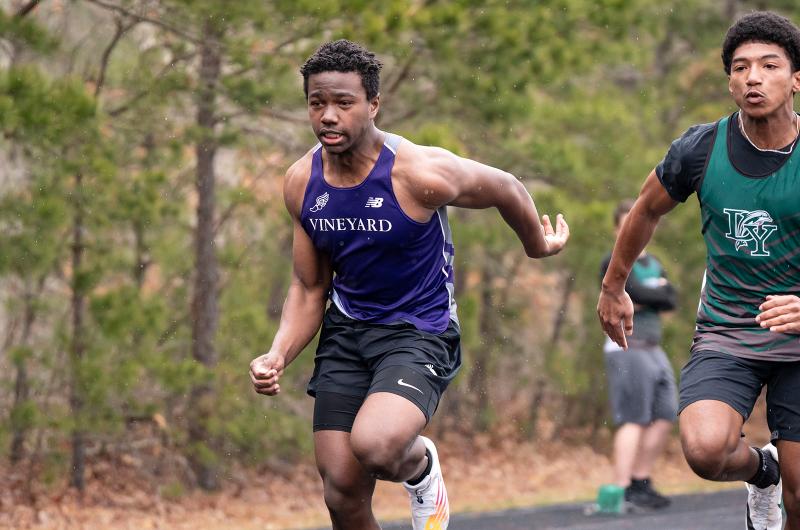 Vineyard athlete giving it his all against a Dennis-Yarmouth athlete.