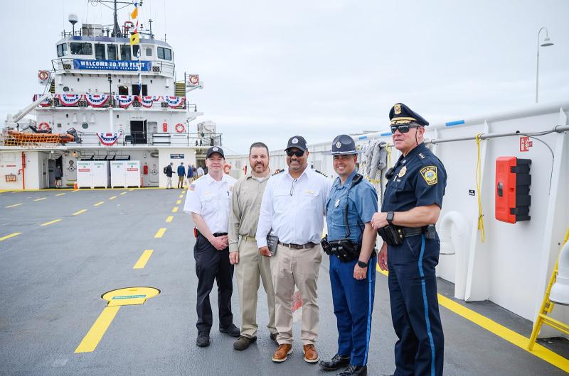 Island law enforcement officials pose with Justin Bond and Captain Norman DeBarros.
