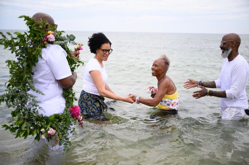 Dr. Frances Gaskin getting into the water with the help of Knowhere Art Gallery owner Valerie Francis.