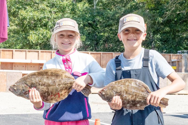 Julia and Jayson Komalski with two good sized fluke.