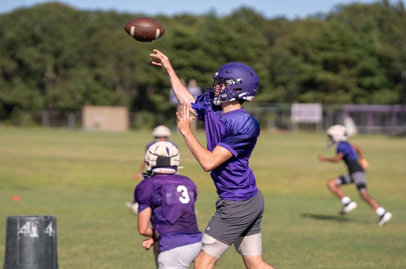 Quarterbacks practice throwing mechanics.