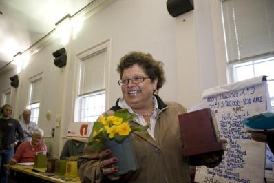 woman smiling and carrying flowers
