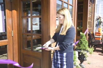 cuts ribbon.