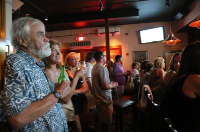 Christine Todd watches The Vineyard at a bar