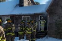 Firemen go inside to put the fire out.