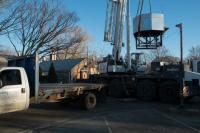 Baxter Crane lifts the stove from Lattanzi's