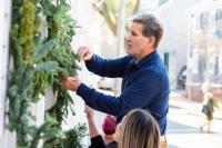 Mark Jenkins of Wallace & Co. putting up holiday decorations in Edgartown.