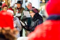 "Silent Night," "Hark the Herald Angel Sing," and "God Rest Ye Merry Gentlemen" rang through the streets.