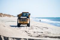Truck returning from South Beach to pick up more sand.