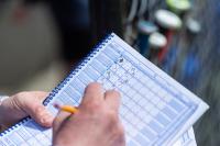 Coach Pete Lambos marking his score card.