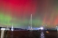 Steamship ferry entering under the Aurora Borealis.
