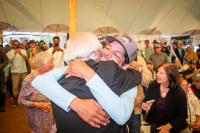 Carmelo Torres gets a hug from Mike Cassidy, who weighed in the winning fish.