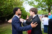 Aiden Weiland helps Jordan Souza with his tie.